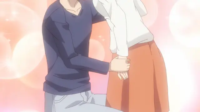 A man in a blue sweater kneels down and holds the hand of a woman in a white shirt and orange skirt against a sparkling pink background. Screenshot from Eternity: Shin`ya no Nurekoi Channel - Episode 9