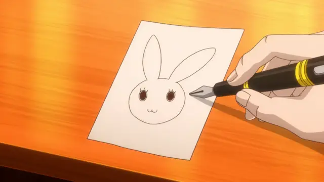A hand holds a black and gold pen, drawing a simple line on a piece of paper featuring a minimalist bunny face. Screenshot from Eternity: Shin`ya no Nurekoi Channel - Episode 9