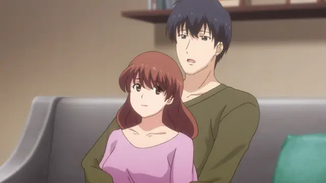 A tall, dark-haired man with a surprised expression sits on a couch behind a shorter woman with reddish-brown hair who is wearing a pink off-the-shoulder top. Screenshot from Eternity: Shin`ya no Nurekoi Channel - Episode 10