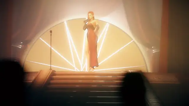 A woman in a long red dress stands on a stage in front of a bright, sun-like light fixture while holding a microphone. Screenshot from Songbird's Shame