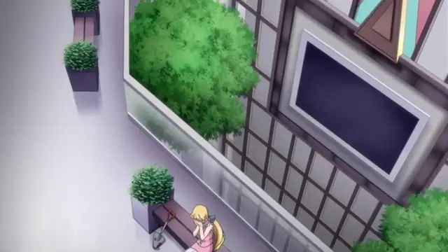 A blonde anime girl in a pink dress stands on a sidewalk next to a bench and a tree-filled building with a large window. Screenshot from Kansen 2 Inzai Toshi - Episode 1