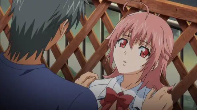 A pink-haired girl with red eyes and a school uniform looks up with a startled expression at a dark-haired man standing in front of her in a wooden balcony setting. Screenshot from Kansen 2 Inzai Toshi - Episode 1