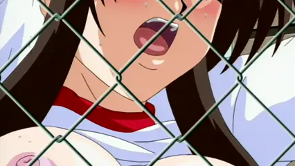 A blushing anime girl with long black hair and an open mouth is seen through a chain-link fence, wearing a white and red outfit with her breasts exposed. Screenshot from Futari no Aniyome - Episode 2