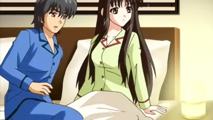 A man in blue pajamas sits on a bed next to a woman in a green robe who is wrapped in a white blanket, both looking surprised as if they have just woken up. Screenshot from Futari no Aniyome - Episode 1