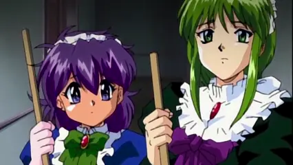 Two anime girls with ruffled headbands and elaborate dresses stand side-by-side holding wooden sticks, with the girl on the left looking shocked and sweaty while the girl on the right maintains a neutral expression. Screenshot from Hinadori no Saezuri - Episode 2