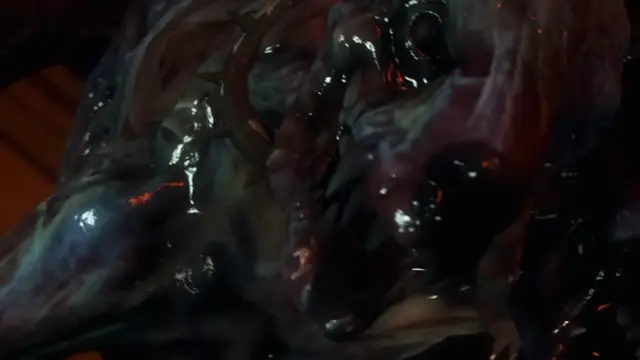 A macro close-up of a glistening, wet monster's fleshy body featuring dark orifices and organic spikes. Screenshot from Kunoichi 2 Extra - Beastly Bacchanalia